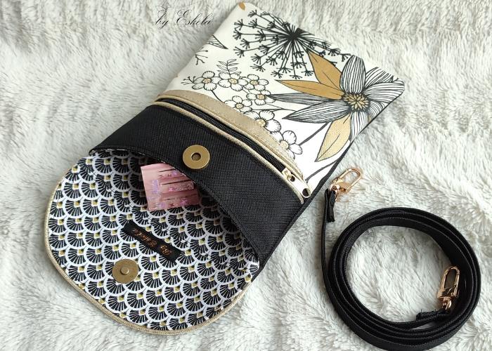 Pochette Annie noire et dorée avec motifs fleuris